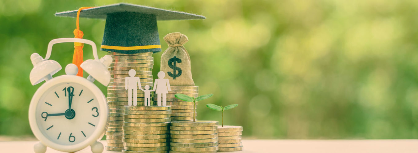 Public school funding / education funding, financial concept : Black graduation cap / hat, family members and kid, US dollar bag on rows of rising coins, white clock on a table, green bokeh background.