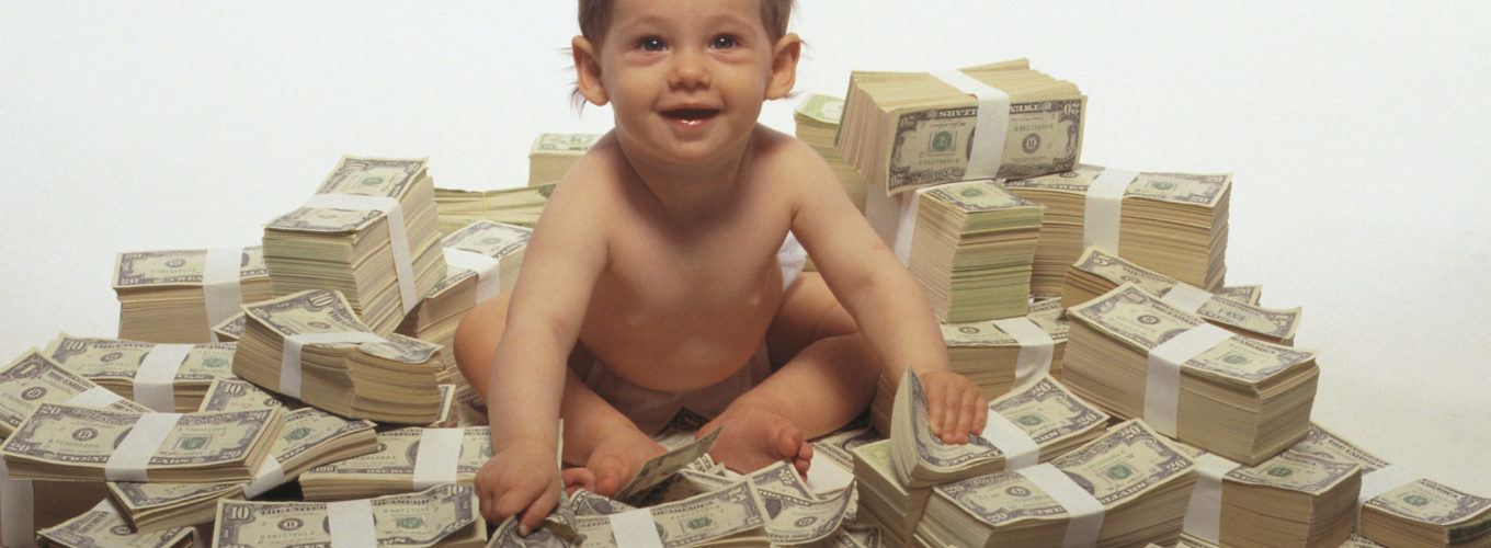 Baby sitting on pile of money